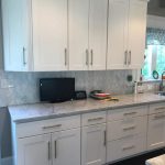 White cupboards with light grey stone top